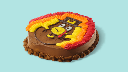 A cake celebrating a baseball team's victory, adorned with team colors and logo, decorated with red and yellow frosting designs and an edible baseball player figurine on top.
